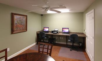 Business center with computers and conference table at the Haven at Reed Creek Apartments Martinez, GA